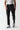Black track pants close-up, elastic hems and tapered straight legs