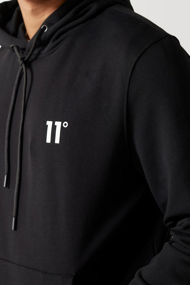 Black hoodie close-up with '11°' chest print and drawstring cord