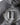 Slate grey hoodie fabric close-up with large circular crest graphic