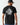 Back of black crew-neck T-shirt with large circular crest graphic