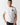 White crew-neck T-shirt with crest emblem on left chest