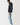 Black hoodie side view with blue sleeve text graphic and relaxed fit.