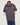 Dark gray puffer jacket with hood, back view, and quilted baffle panels
