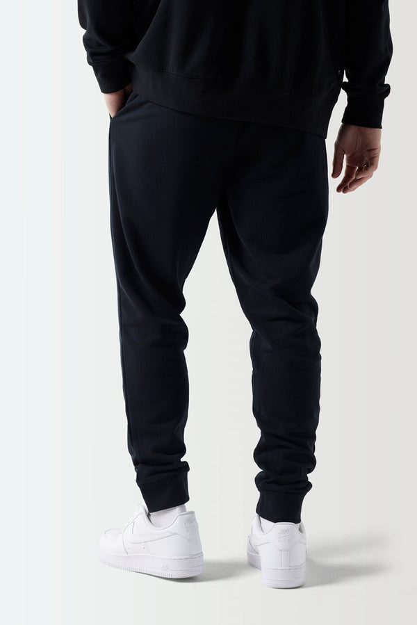 Men's black tapered joggers with elastic cuffs and ankle hem