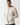 Light beige full-zip hoodie with drawstring hood and small chest logo