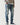Mid-blue ripped jeans with multiple distressed patches and frayed cuffs
