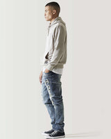 Mid-blue ripped jeans with distressed thigh and knee patches