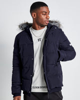 Men's dark puffer jacket with faux-fur hood trim and chest logo patch