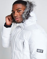 White padded jacket hood with gray fur trim and sleeve logo patch