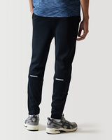 Black athletic pants with white knee stripe and ankle-cuff panels.
