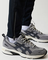 Black athletic pants with ankle zipper and side pocket seam detail.