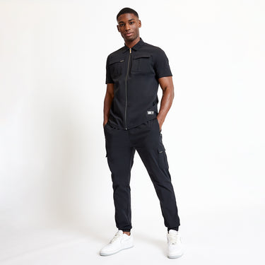 Black utility short-sleeve shirt with zip front, chest pockets, and side utility styling