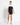 Black-and-white swim outfit with black belted swim shorts shown from side