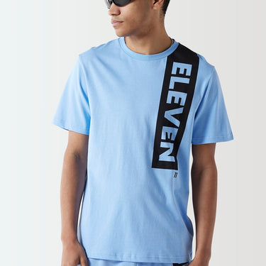 Men's light blue t-shirt with black ELVEN vertical graphic at the chest