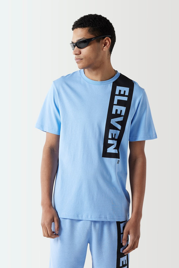 Men's light blue t-shirt with black ELVEN vertical graphic at the chest