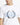 White crew-neck T-shirt with large blue and black crest graphic detail