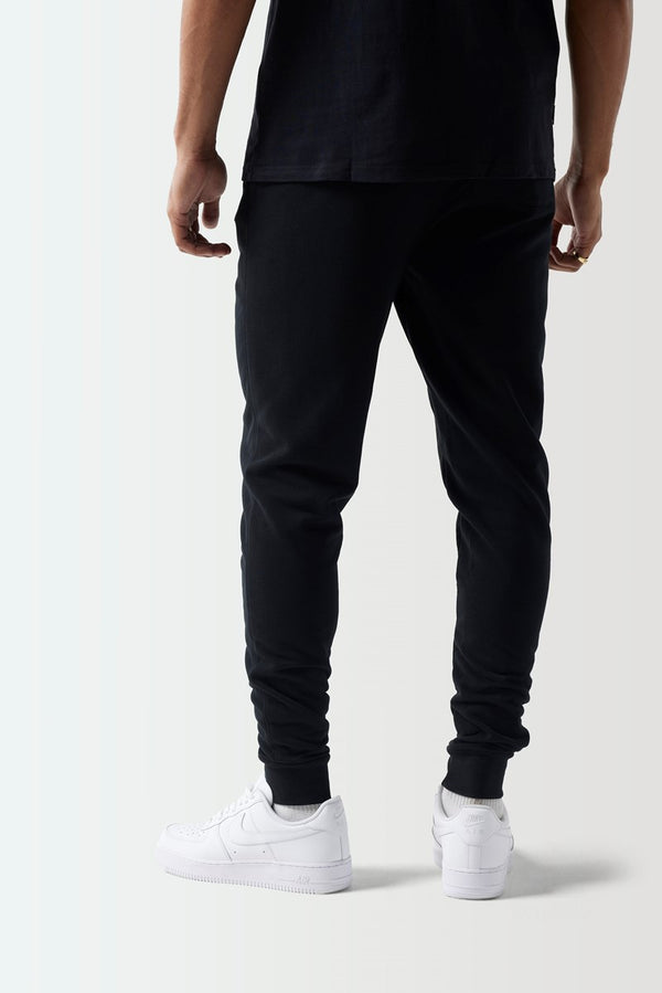 Black skinny-fit joggers with tapered legs and ankle cuffs