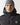 Black micro puffer jacket with hood collar, zip front, and 11° chest logo