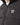 Black puffer jacket close-up: full-zip front, standing collar, and “11°” chest logo
