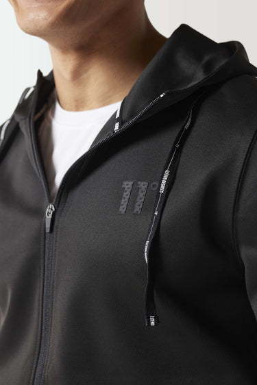 Black full-zip hoodie close-up at collar and chest with visible zipper