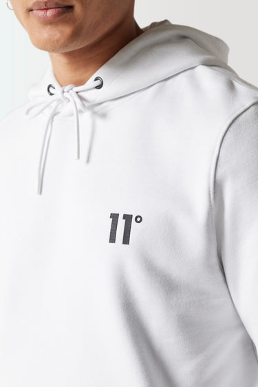 White hoodie close-up of drawstring neck and '11°' chest logo