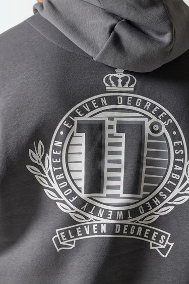 Slate grey hoodie fabric close-up with large circular crest graphic
