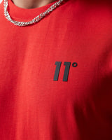 Fiery red t-shirt front with '11°' print and silver chain at neckline