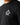 Black crew-neck T-shirt with small circular crest logo on left chest