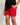Red junior swim shorts with elastic waistband and small black 11° logo