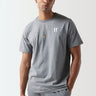 A model wearing a grey Core T-Shirt with the 11 Degrees logo on the chest.