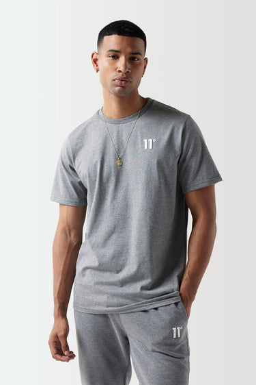A model wearing a grey Core T-Shirt with the 11 Degrees logo on the chest.