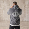 Slate grey hoodie with hood up and large crest graphic on back