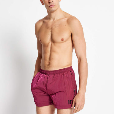 Maroon micro taped swim shorts with elastic waistband, short leg and side taping.