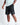 Black sweat shorts with right-thigh logo patch and side pockets
