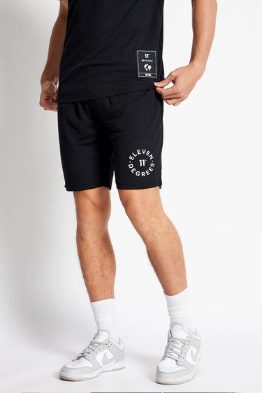 Black mesh shorts with small front logo label and 'Eleven Degrees' text